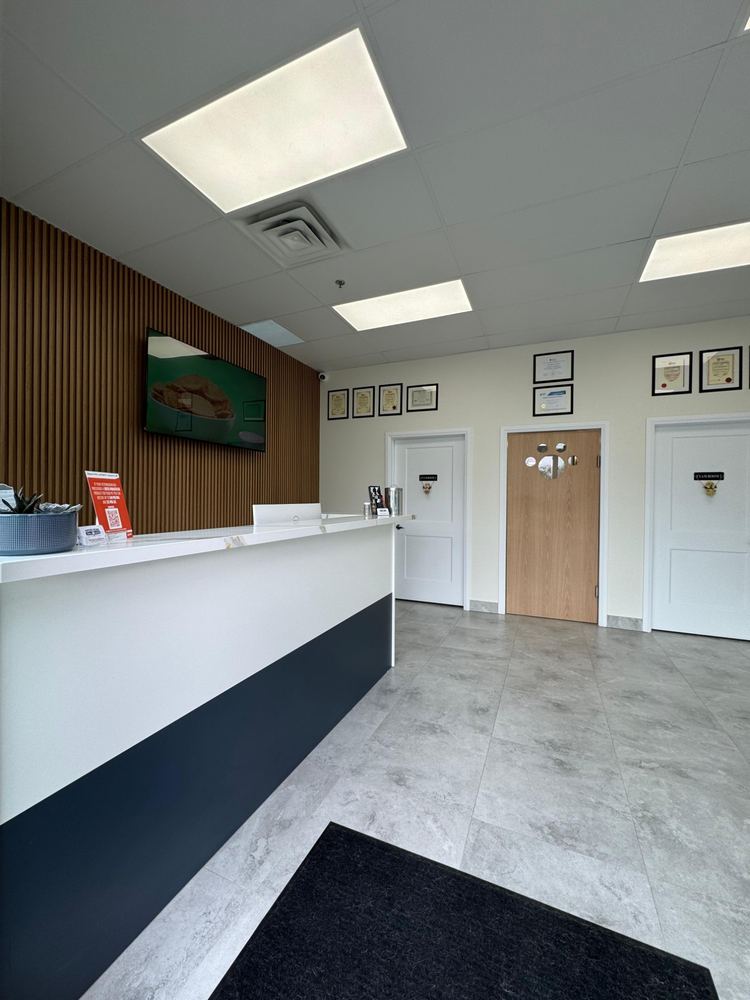 Reception desk with a wood slat feature wall and exam room doors
